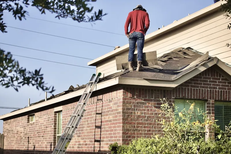 Professional roofer working on a residential roof in Orchard Park